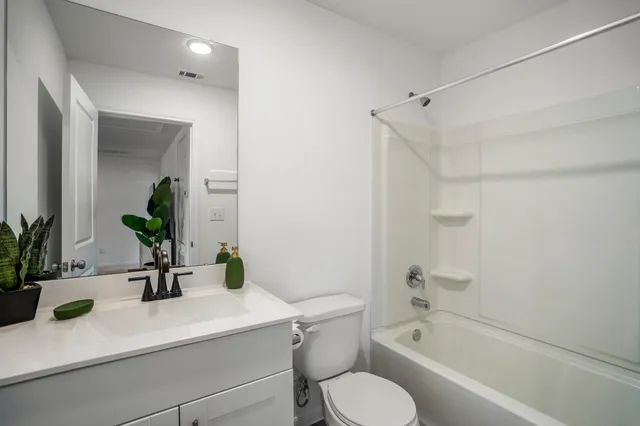 a bedroom with a bed and a couch