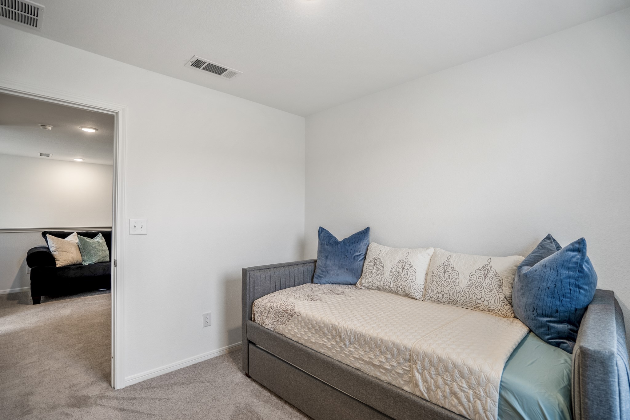 10477 Pineland Drive Willis, TX 77378 - Photo 24 of 27 a bedroom with a bed and a couch