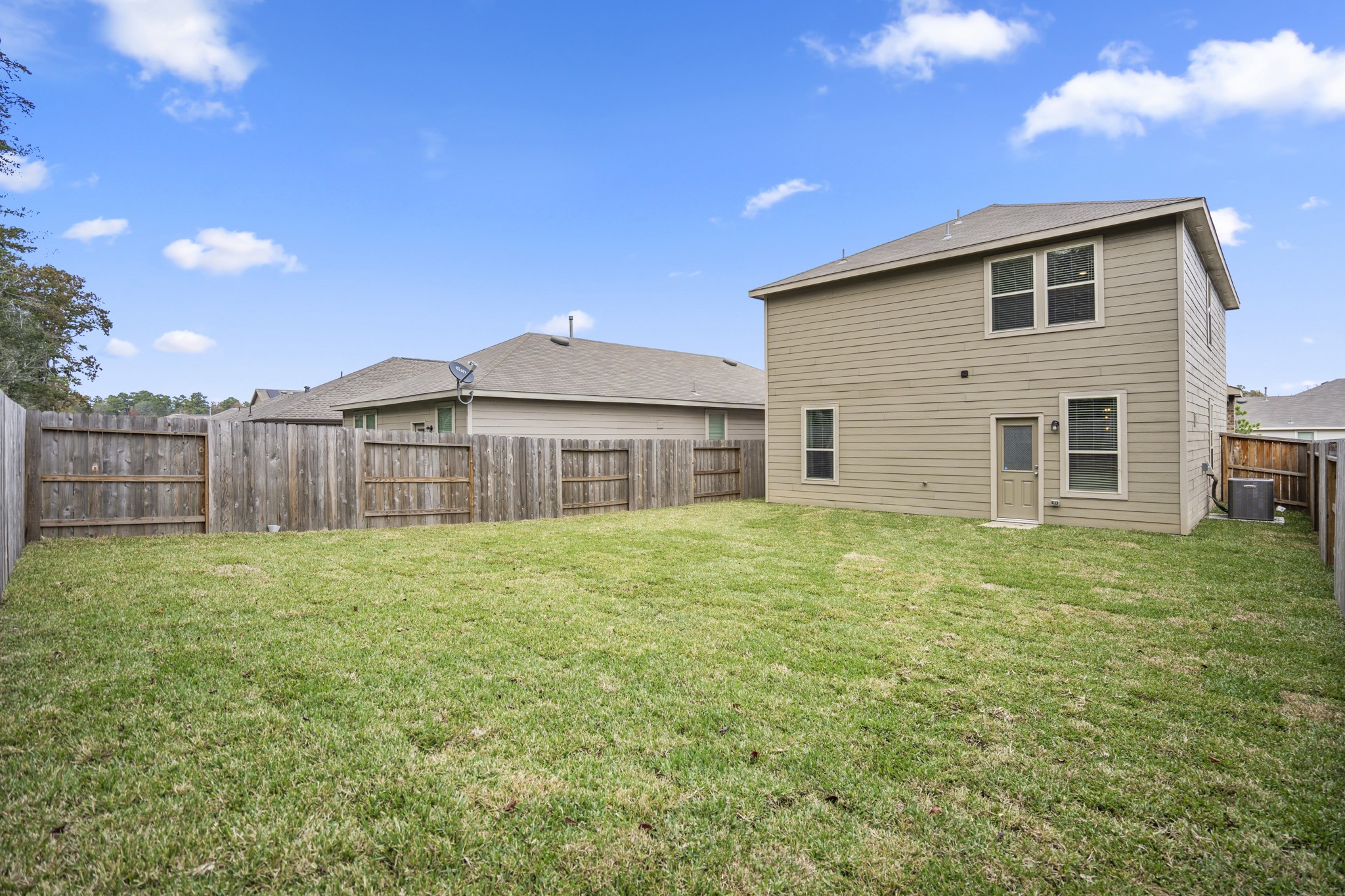 10477 Pineland Drive Willis, TX 77378 - Photo 27 of 27 a view of a backyard with wooden fence