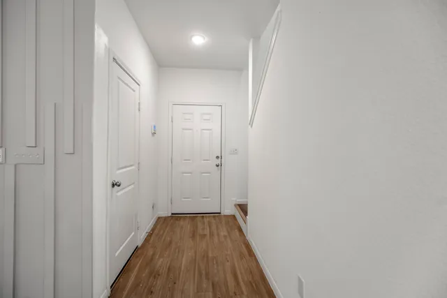 a living room with furniture a flat screen tv and a window