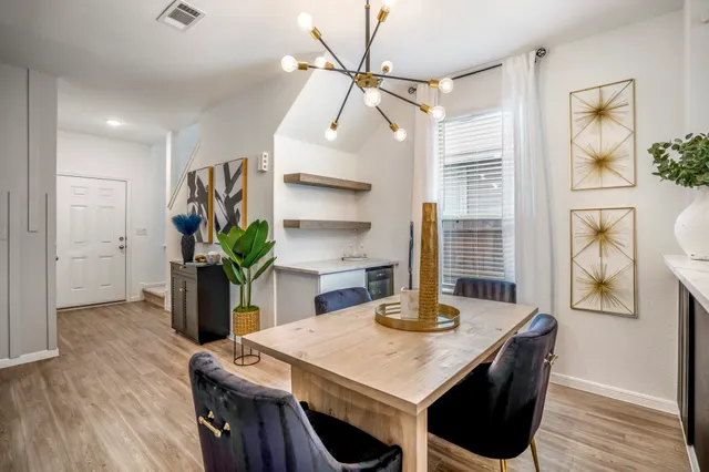 a view of a dining room with furniture and wooden floor
