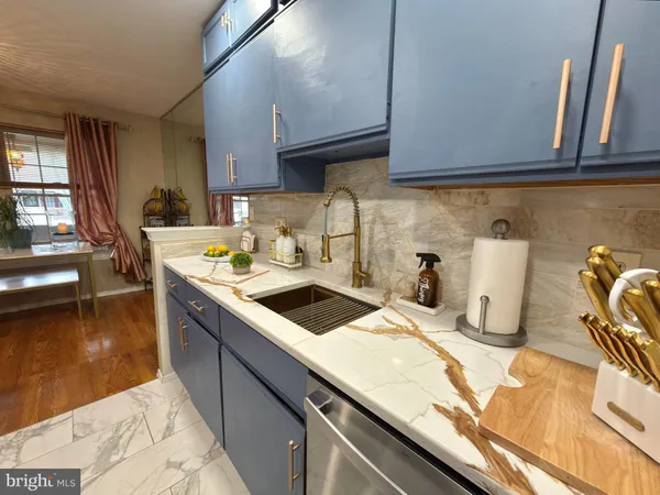 a kitchen with a sink a stove and cabinets