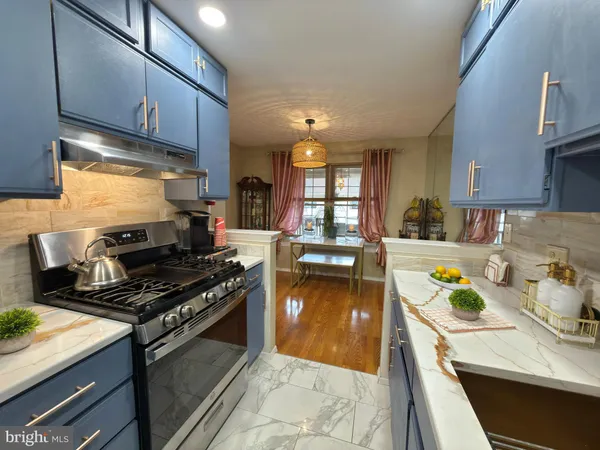 a kitchen with a stove a sink and a refrigerator
