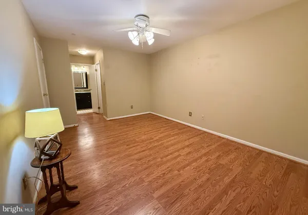 a view of an empty room with a ceiling fan