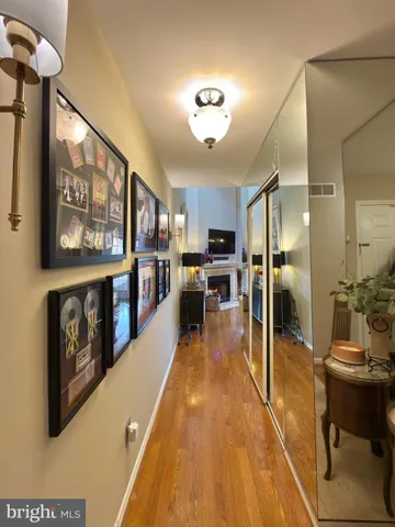 a view of a kitchen with kitchen island stainless steel appliances refrigerator stove top oven and sink
