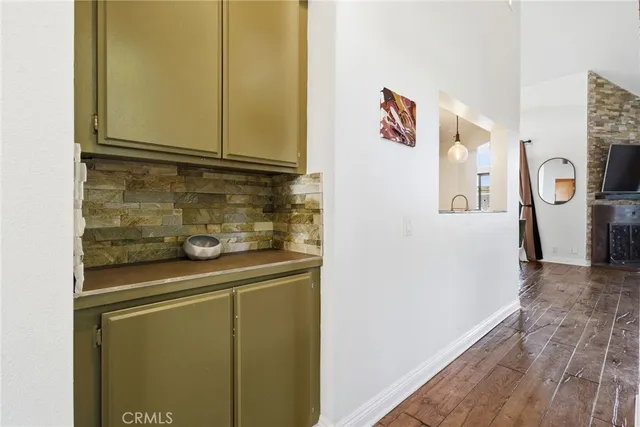 a view of front door with wooden floor and windows