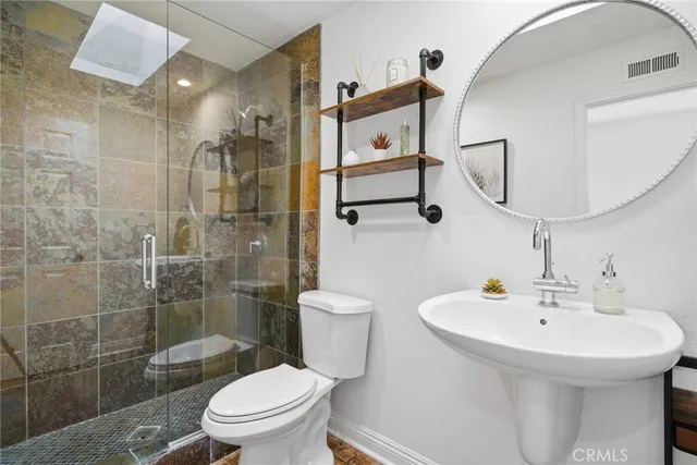 a bedroom with a bed wooden floor and window