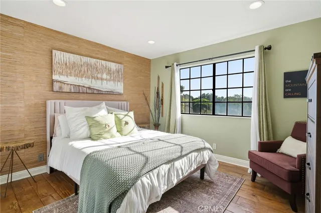 a bedroom with a bed a dresser and a window