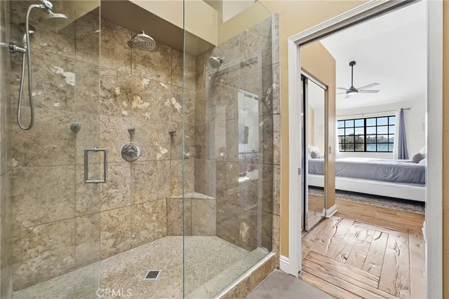 a view of a hallway with wooden floor and living room