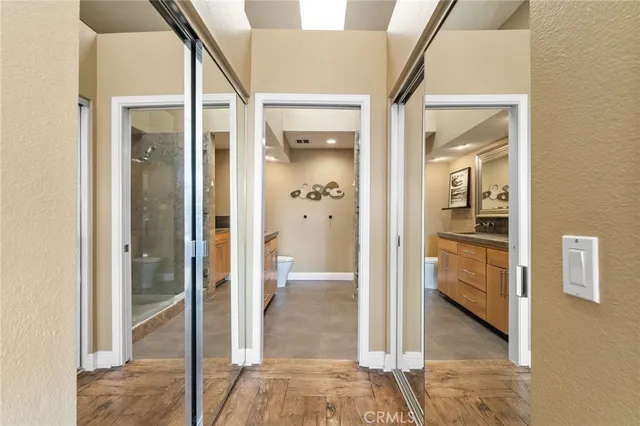 a bathroom with a granite countertop sink mirror vanity and toilet
