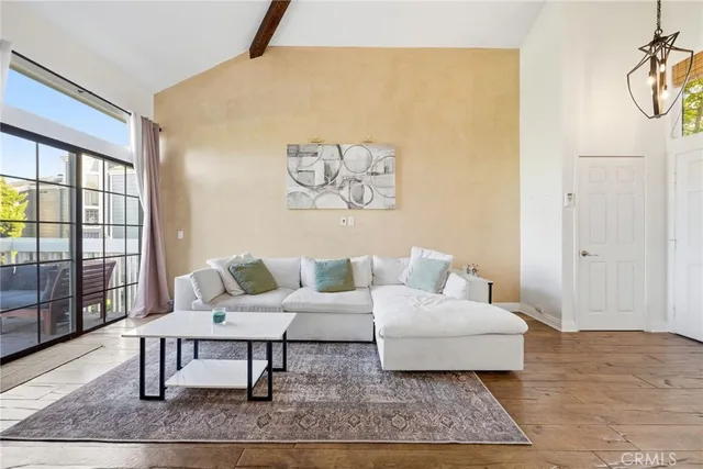 a view of a dining room with furniture a chandelier and wooden floor