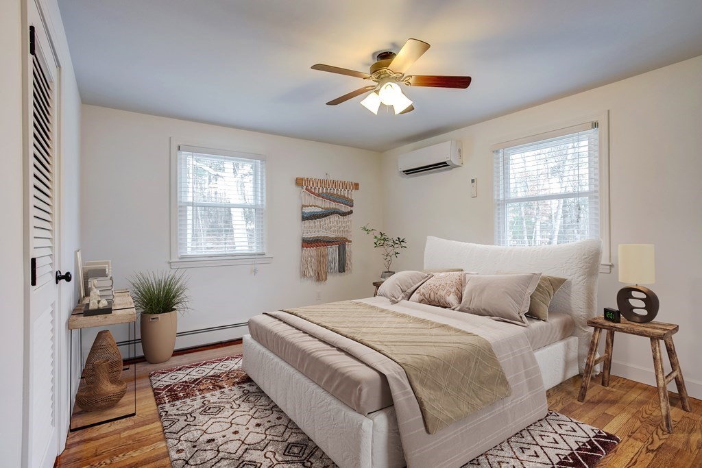 31 Sargent Road Bolton, MA 01740 - Photo 8 of 11 a bedroom with a large bed and a chandelier