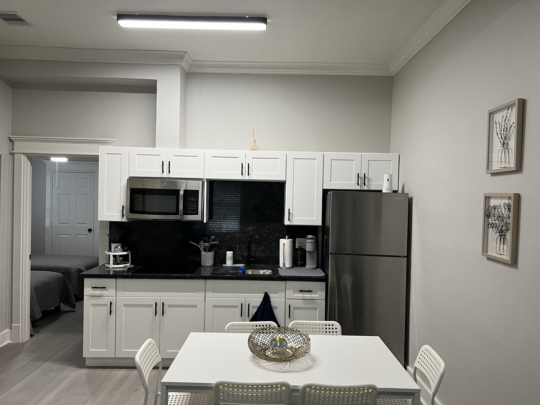 220 Redan Street, Unit A Houston, TX 77009 - Photo 6 of 22 a kitchen with stainless steel appliances a refrigerator a sink a stove a microwave a dining table and chairs