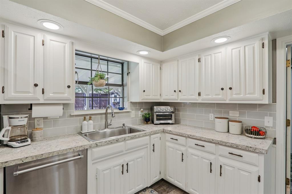 149 South Moore Road Coppell, TX 75019 - Photo 11 of 40 a kitchen with stainless steel appliances granite countertop a sink stove and cabinets
