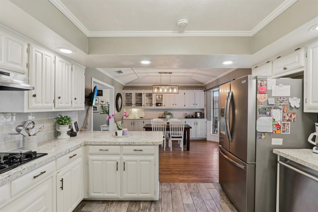 149 South Moore Road Coppell, TX 75019 - Photo 13 of 40 a kitchen with white cabinets and stainless steel appliances