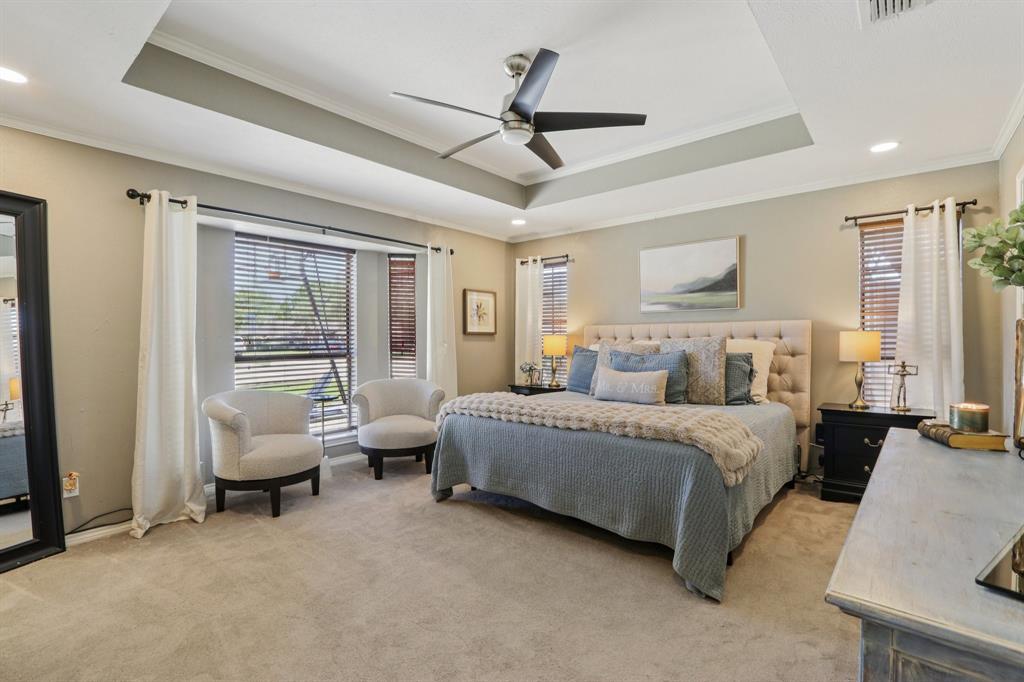 149 South Moore Road Coppell, TX 75019 - Photo 17 of 40 a spacious bedroom with a bed and glass windows