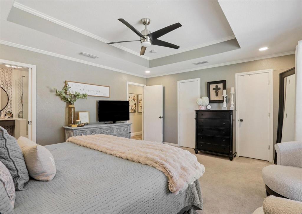 149 South Moore Road Coppell, TX 75019 - Photo 18 of 40 a bedroom with a bed and a ceiling fan