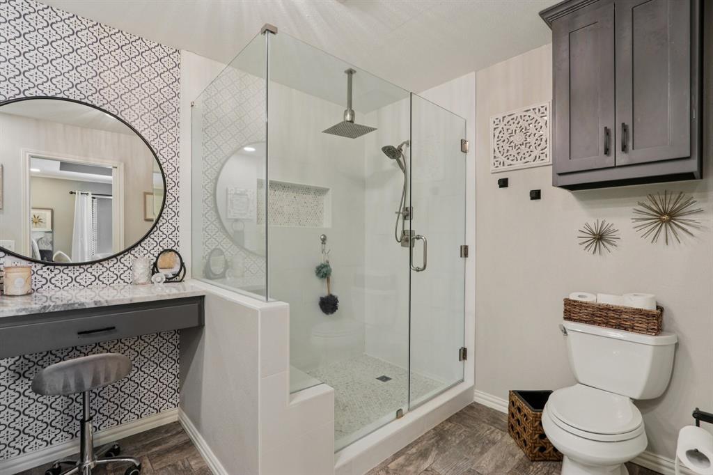 149 South Moore Road Coppell, TX 75019 - Photo 22 of 40 a bathroom with a toilet a sink and shower