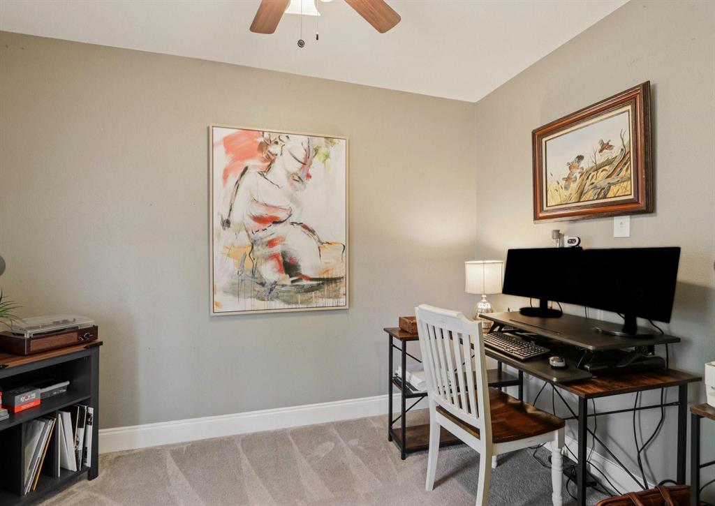 149 South Moore Road Coppell, TX 75019 - Photo 24 of 40 a view of a workspace with furniture and a bookshelf