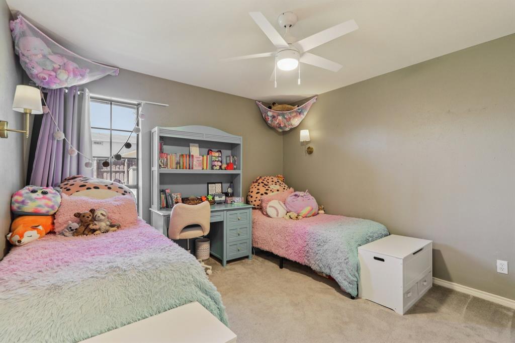 149 South Moore Road Coppell, TX 75019 - Photo 25 of 40 a bedroom with a bed and a chandelier