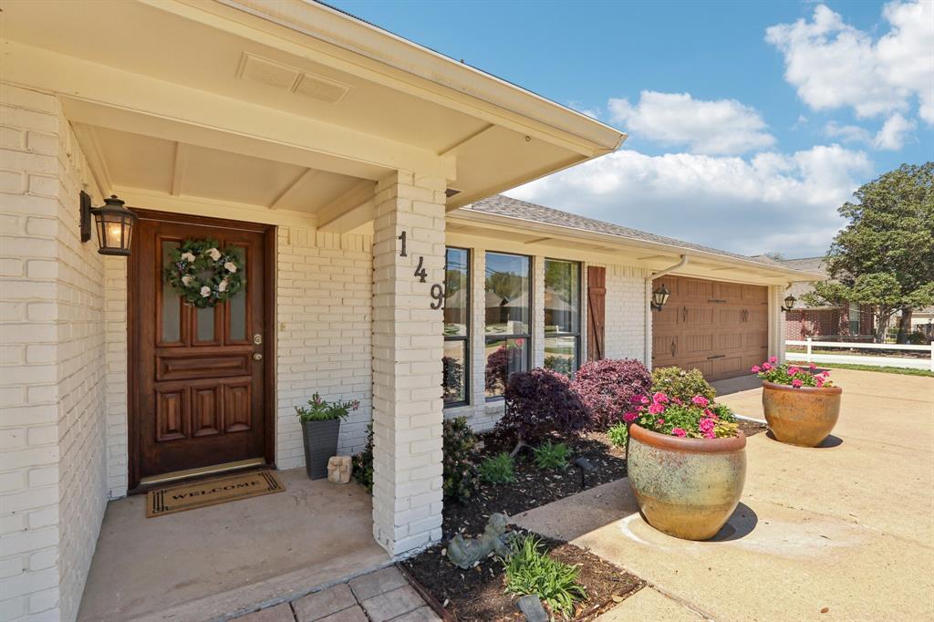 149 South Moore Road Coppell, TX 75019 - Photo 3 of 40 a front view of a house with an outdoor space