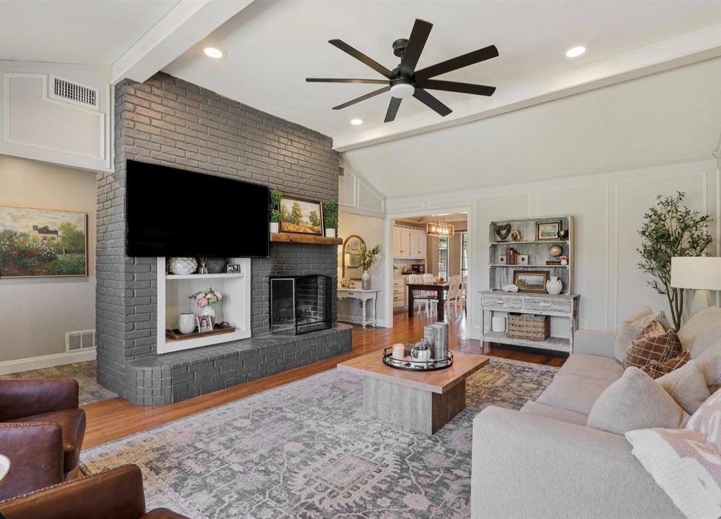 149 South Moore Road Coppell, TX 75019 - Photo 7 of 40 a living room with fireplace furniture and a flat screen tv