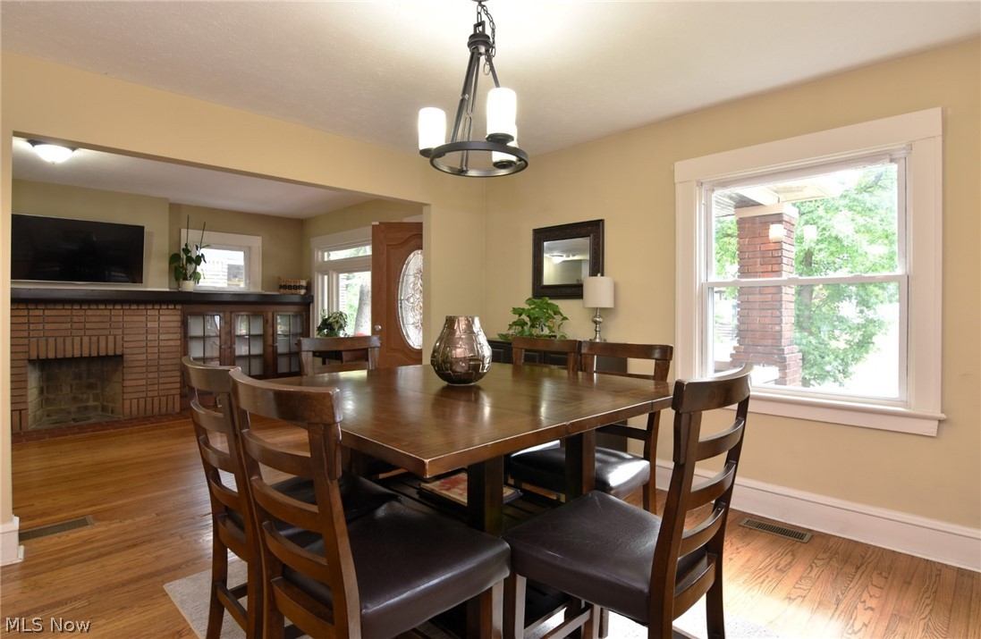 3584 Pennington Road Cleveland, OH 44120 - Photo 17 of 42 Dining room with an inviting chandelier, hardwood / wood-style floors, and a wealth of natural light