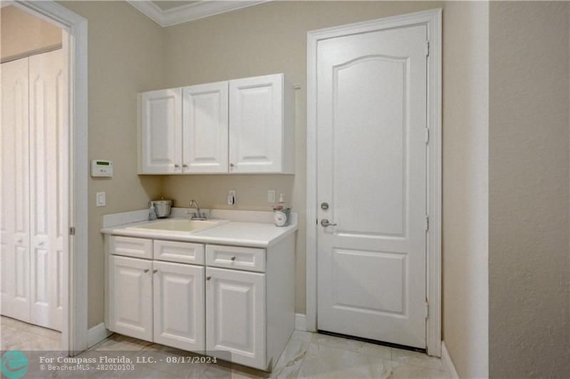 8631 Lakeside Bend Parkland, FL 33076 - Photo 24 of 71 a utility room with cabinets washer and dryer