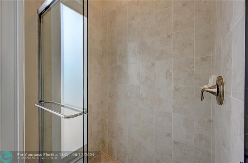 8631 Lakeside Bend Parkland, FL 33076 - Photo 27 of 71 a bathroom with a glass shower door