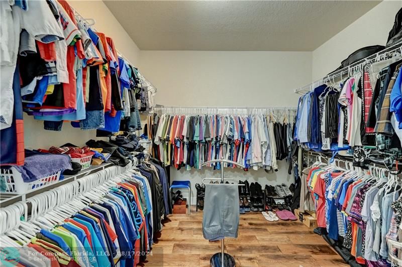 8631 Lakeside Bend Parkland, FL 33076 - Photo 38 of 71 a view of walk in closet with clothes and shoes