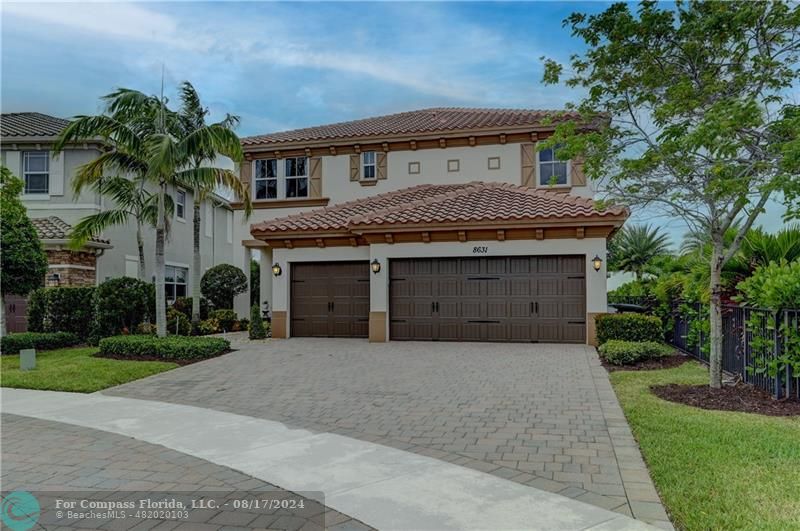8631 Lakeside Bend Parkland, FL 33076 - Photo 4 of 71 a front view of a house with a garden and palm trees