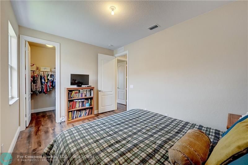 8631 Lakeside Bend Parkland, FL 33076 - Photo 43 of 71 a bedroom with a bed and a book shelf