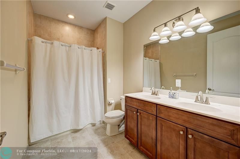 8631 Lakeside Bend Parkland, FL 33076 - Photo 47 of 71 a spacious bathroom with a double vanity sink mirror and toilet