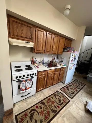 a kitchen with stove and cabinets