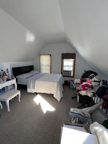 a bedroom with furniture and a window