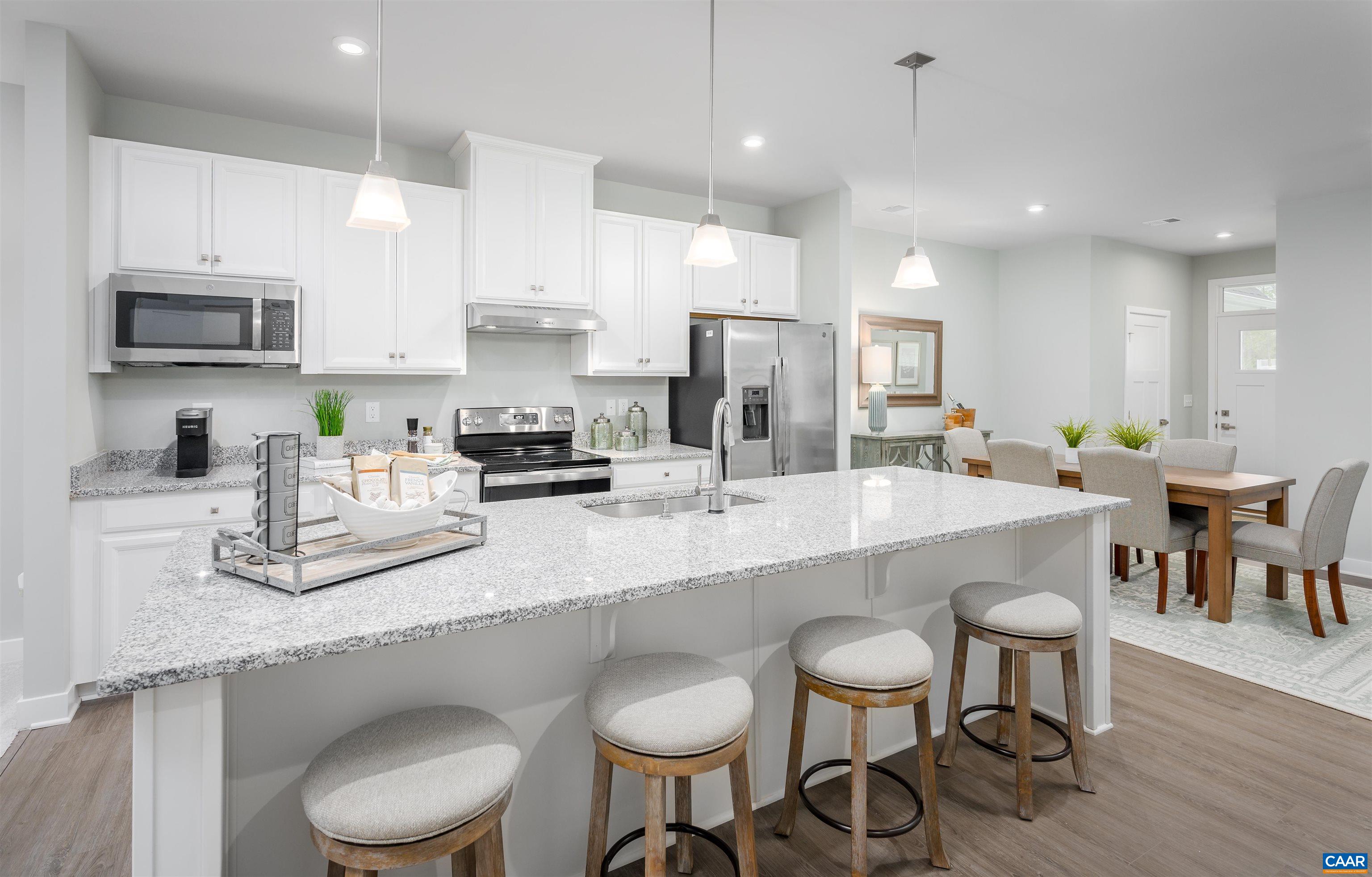 922 Marsac Street Charlottesville, VA 22901 - Photo 9 of 26 a kitchen with stainless steel appliances granite countertop a white table and chairs in it