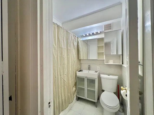 a white toilet sitting next to a bathroom sink