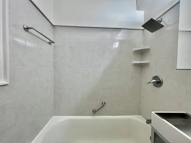 a bathroom with a shower and a bathtub