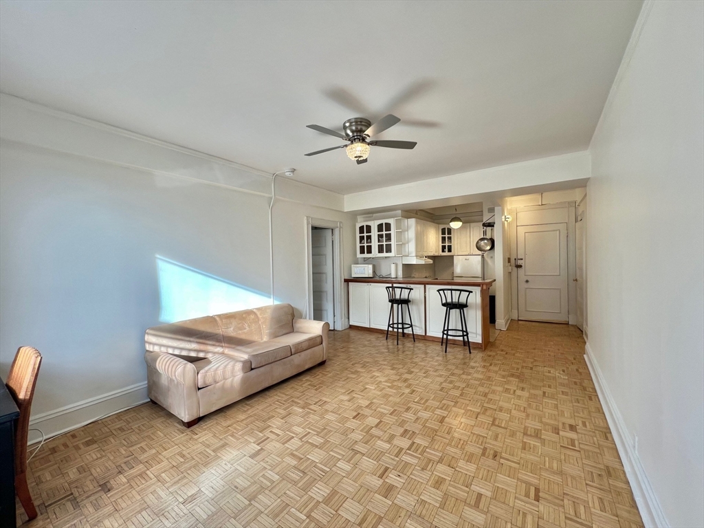 21 Beacon Street, Unit 6T Boston, MA 02108 - Photo 4 of 28 a living room with furniture and a ceiling fan