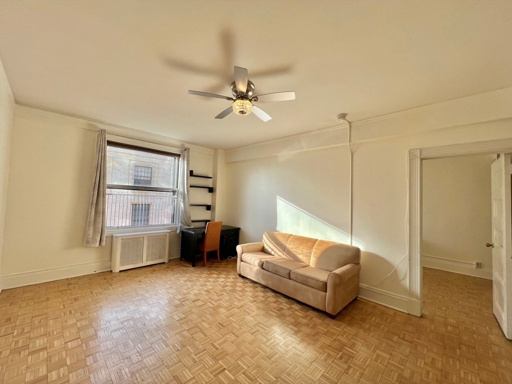 21 Beacon Street, Unit 6T Boston, MA 02108 - Photo 5 of 28 a living room with furniture and a ceiling fan