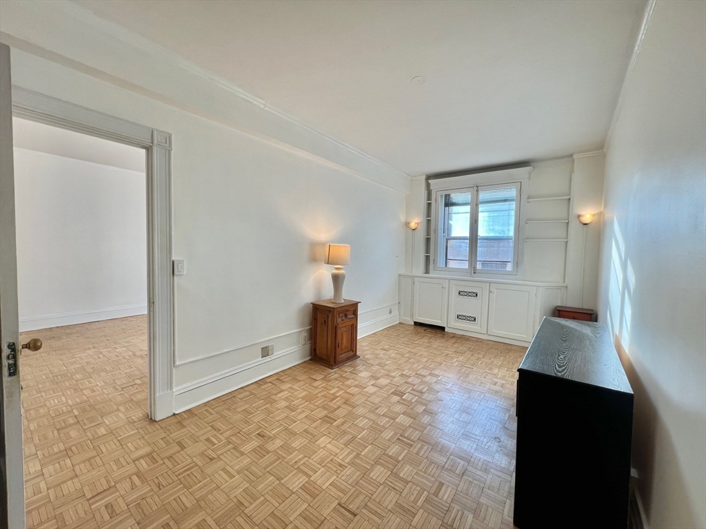 21 Beacon Street, Unit 6T Boston, MA 02108 - Photo 9 of 28 wooden floor in an empty room with a window