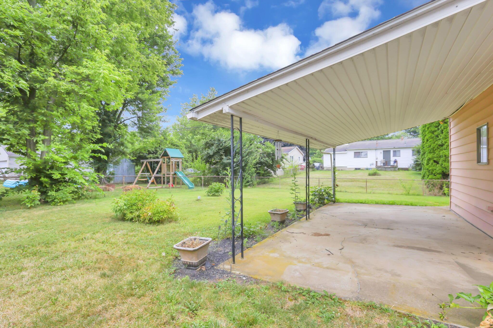 3882 Glenfield Road Columbus, OH 43232 - Photo 24 of 29 Covered patio with concrete flooring, supported by metal posts