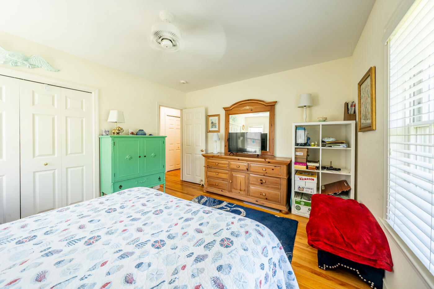 69 Regatta Drive Mashpee, MA 02649 - Photo 18 of 31 a bedroom with a bed and wooden floor