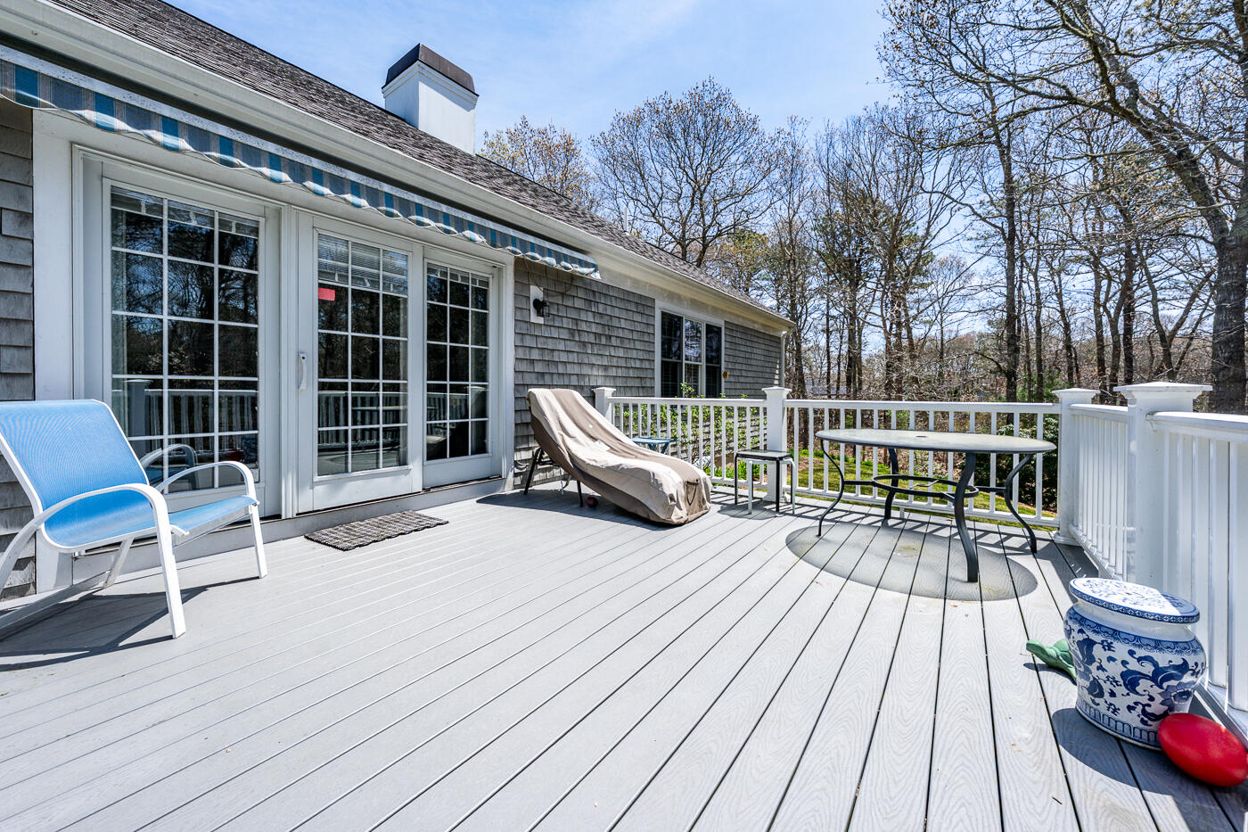 69 Regatta Drive Mashpee, MA 02649 - Photo 4 of 31 a view of a deck with table and chairs and wooden floor