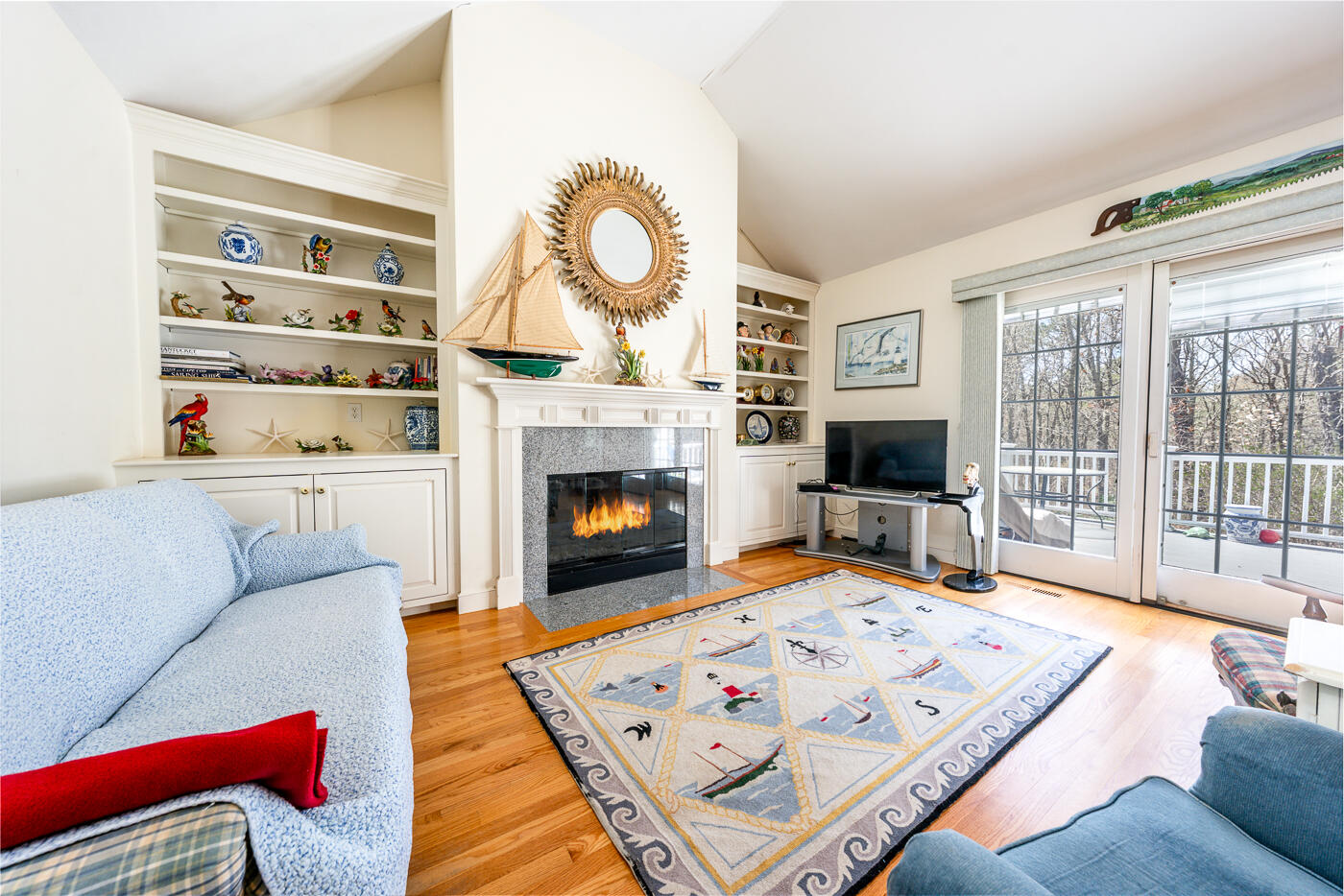 69 Regatta Drive Mashpee, MA 02649 - Photo 9 of 31 a living room with furniture a flat screen tv and a fireplace