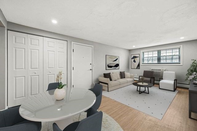 64 Goldthwaite Road, Unit 10 Worcester, MA 01605 - Photo 4 of 13 a living room with furniture a wooden floor and a sink