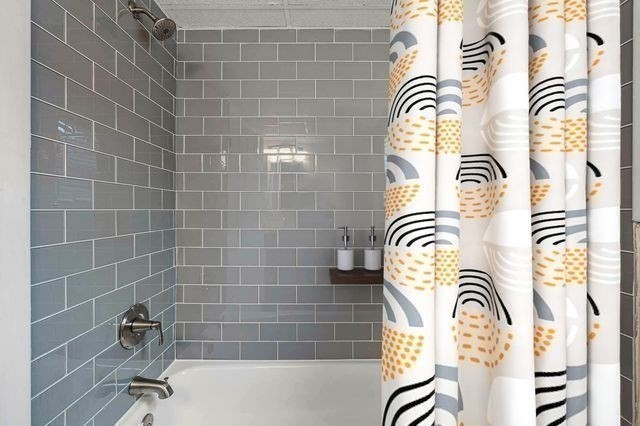 64 Goldthwaite Road, Unit 10 Worcester, MA 01605 - Photo 9 of 13 a bathroom with a bathtub and a shower