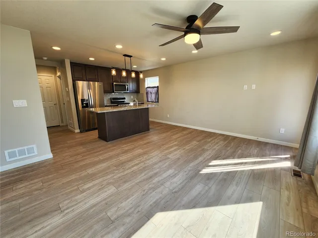 a kitchen with kitchen island a stove and a refrigerator