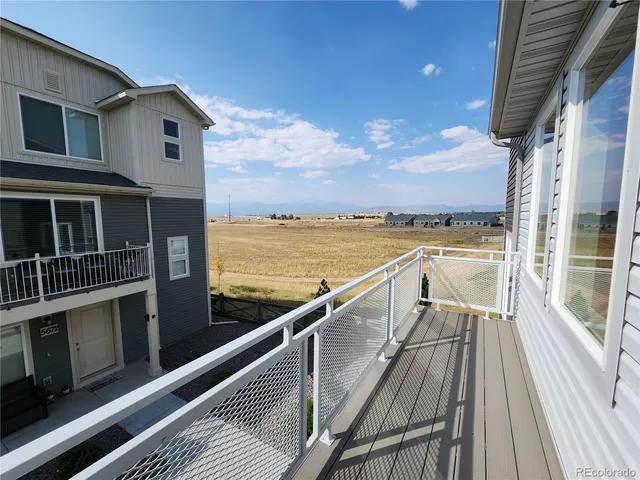 a view of balcony with ocean view and wooden floor