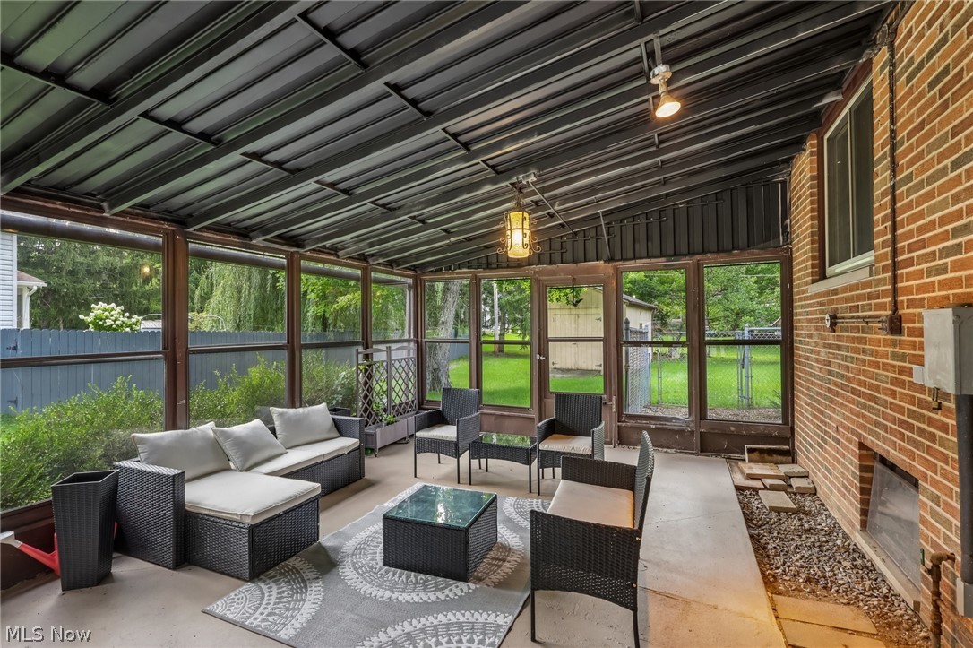 8310 Broadview Road Broadview Heights, OH 44147 - Photo 25 of 32 Screened-in patio with a metal panel roof, exposed brick wall, and concrete flooring